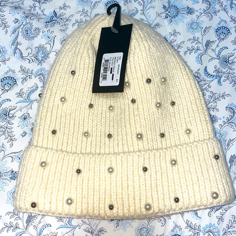 Beige hat with silver and white pearls. Never used. Brand new.